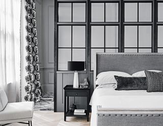 bedroom with black, white and grey interior and glass partion wall