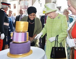 Queen Elizabeth II with Nadiya Hussain, winner of the Great British Bake Off who baked a cake for her, during a walkabout close to Windsor Castle in Berkshire as she celebrates her 90th birthday.