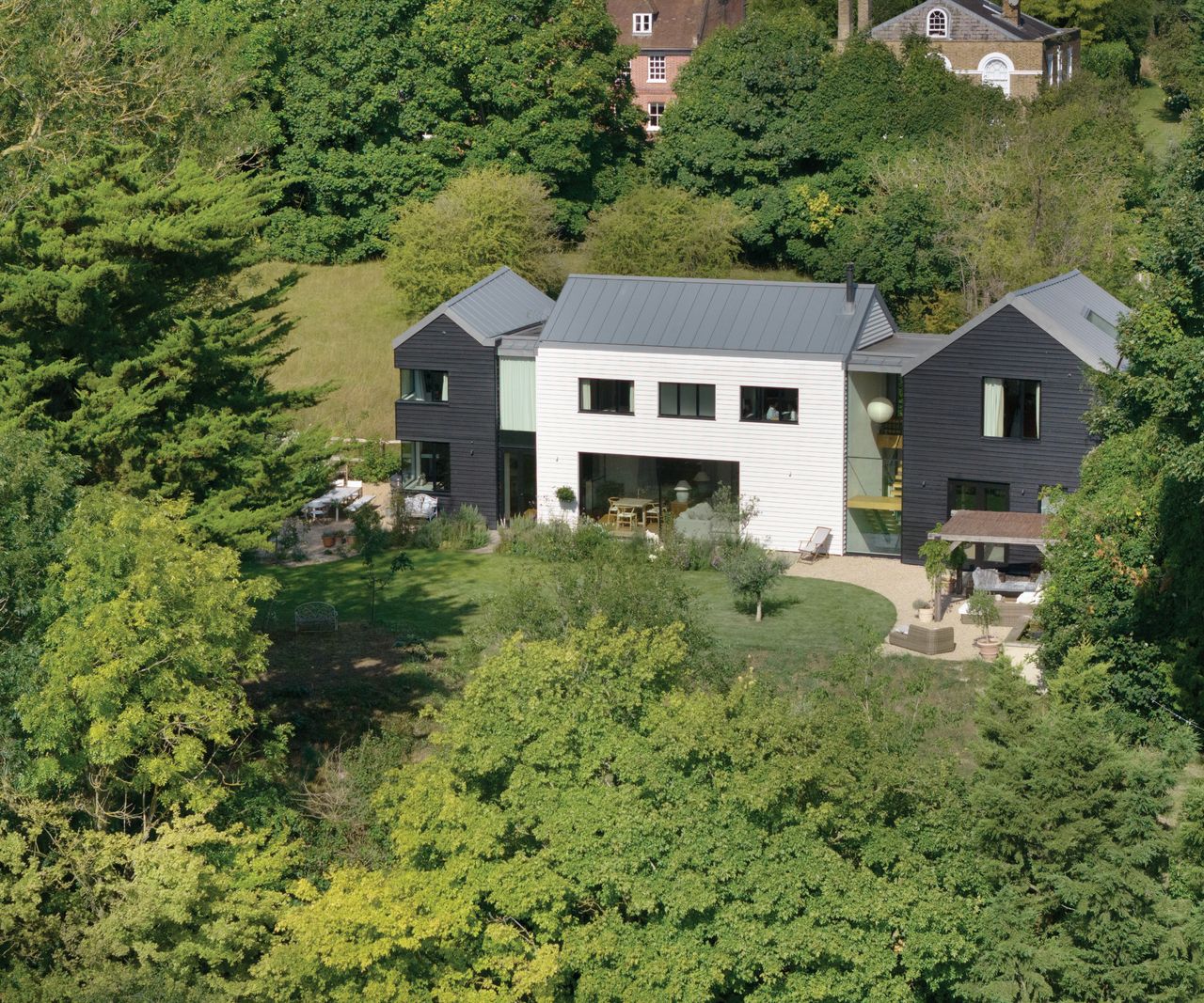 High shot of house with grass and trees surrounding it