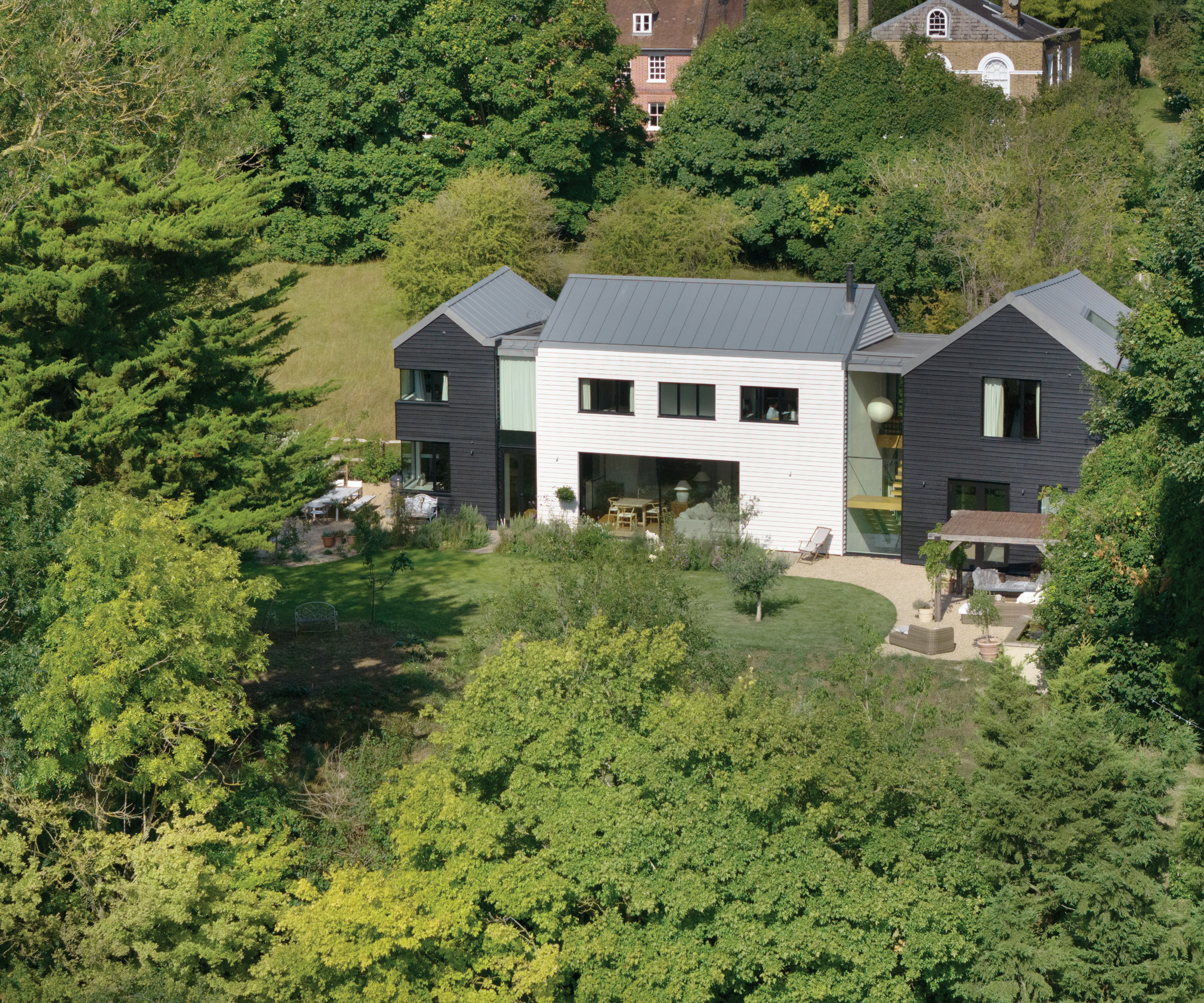 High shot of house with grass and trees surrounding it