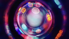 Abstract physics image showing glowing blobs orbiting a central blob.