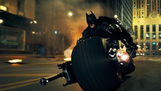 Christian Bale as Batman riding into action on the Batpod in The Dark Knight.