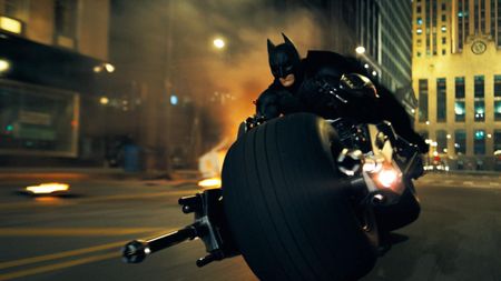 Christian Bale as Batman riding into action on the Batpod in The Dark Knight.