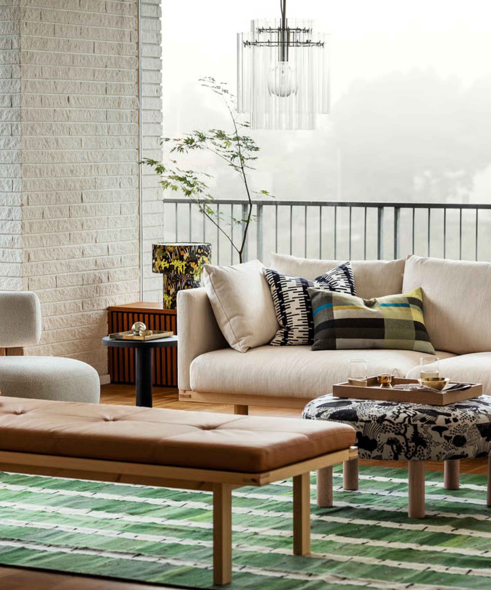 IKEA scandi living room with neutral sofa and a green flatweave rug