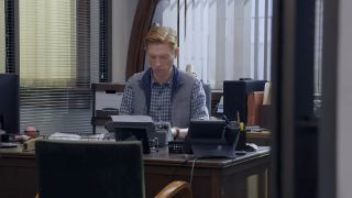 Domhnall Gleeson typing in The Paper.
