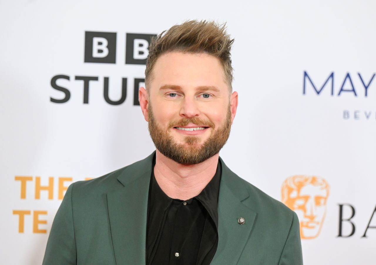 A headshot of Bobby Berk smiling at the camera