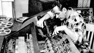 Les Paul tinkers in his studio. 