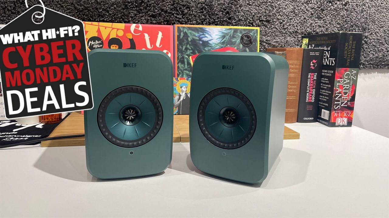 KEF LSX II LT wireless speakers on a desk with a Cyber Monday tag