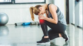 A woman who has injured her knee in the gym