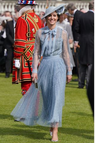 Catherine, Princess of Wales wears a blue dress and silver heels as she attends King Charles III's Coronation Garden Party at Buckingham Palace on May 9, 2023 in London, England.