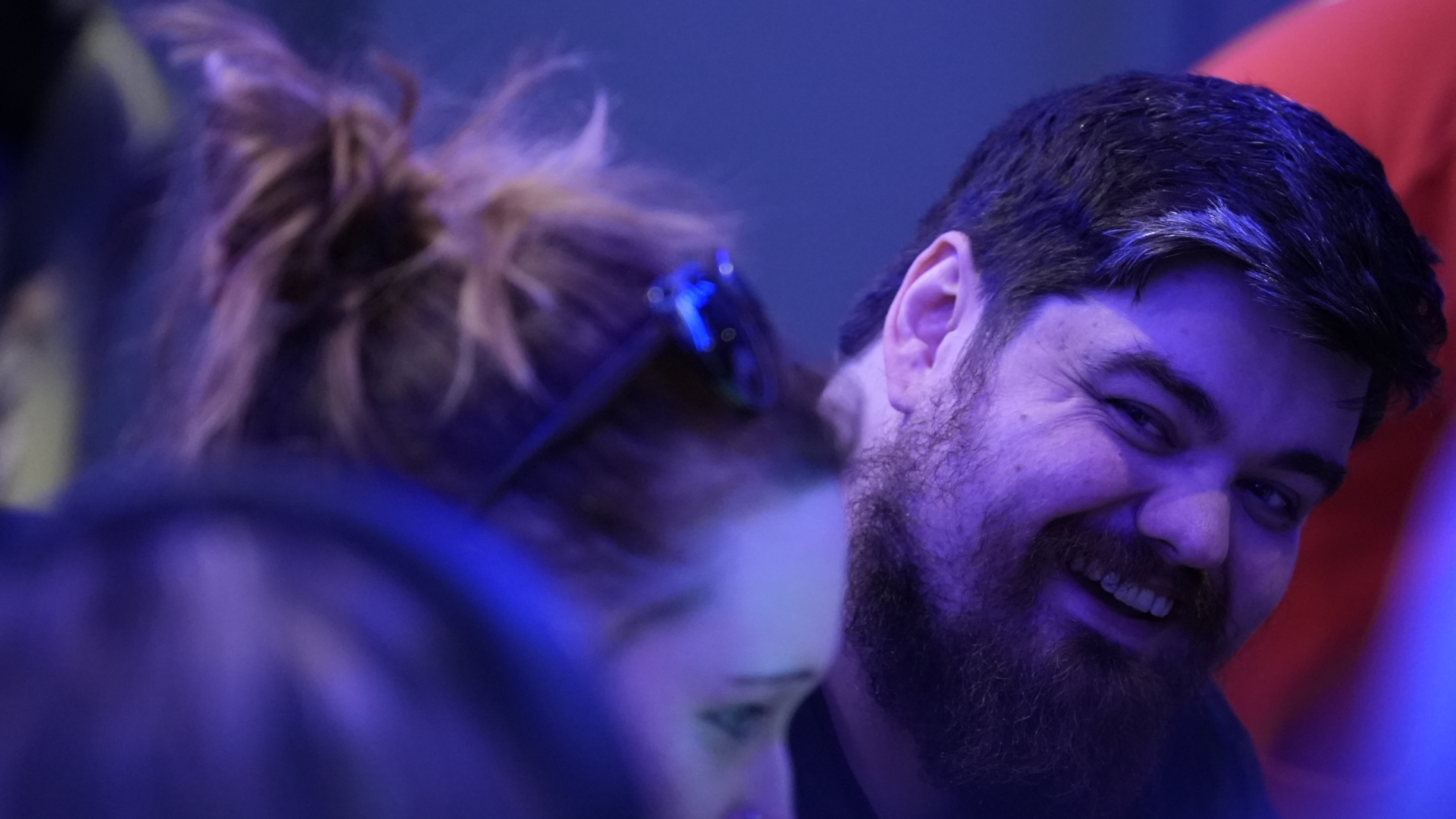 Liam Quinn of Muscular Dystrophy UK, talking with people at a Game On event.