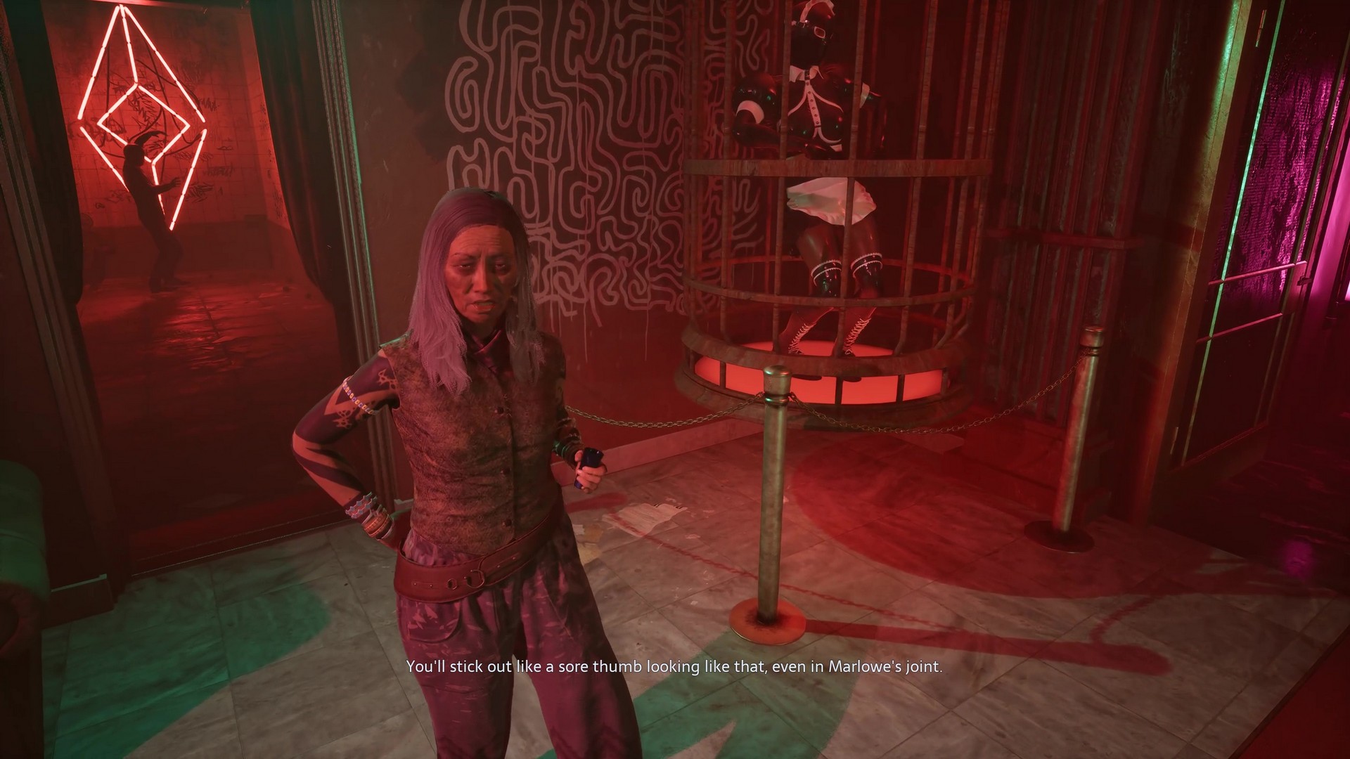 Zora speaks with Aiden in Marlowe's club as a nearby dancer gyrates in Hellraiser: Revival