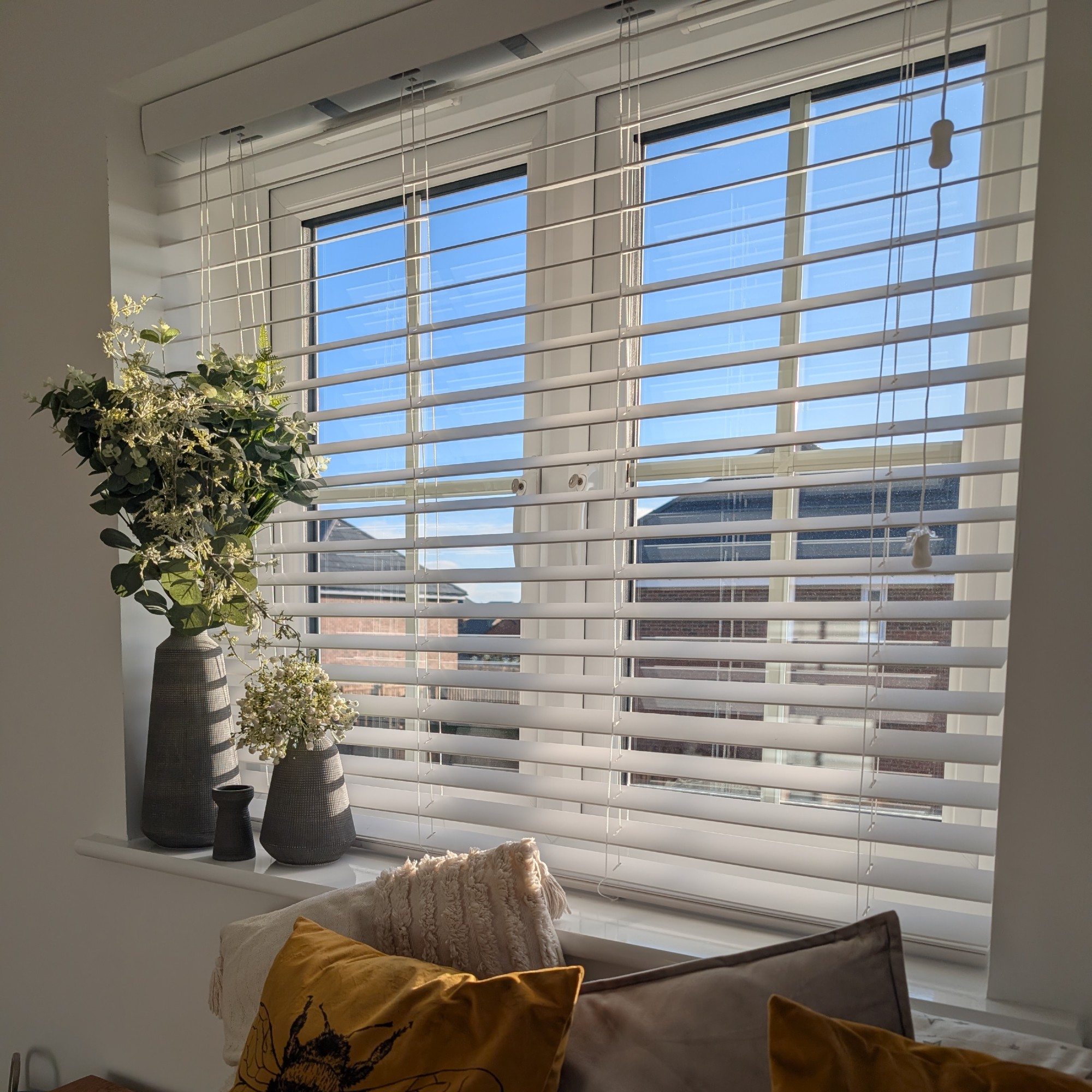 Twist&amp;amp;Fit wooden blinds from 247 Blinds installed on a window decorated with a set of vases with flowers