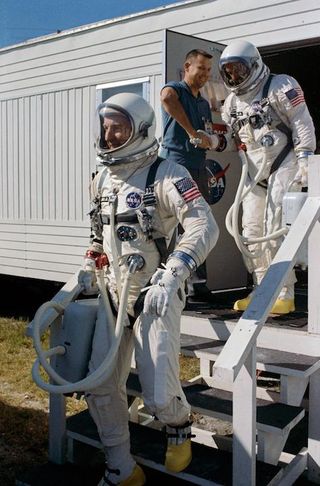 Astronauts Jim Lovell (leading), command pilot, and Edwin "Buzz" Aldrin, pilot, leave the suiting trailer at Launch Complex 16 during prelaunch countdown at Cape Canaveral, Florida.