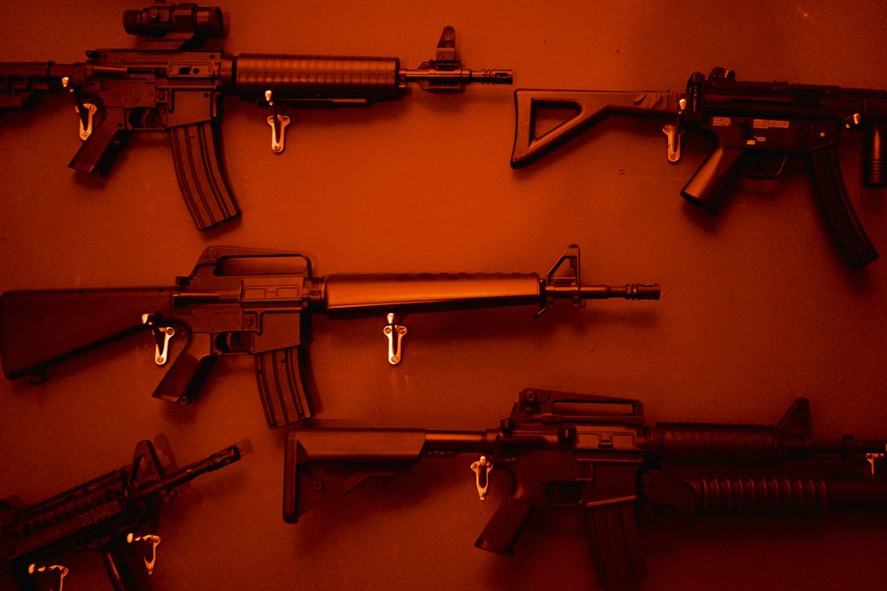 Numerous Assault Rifles Hanging On Wall