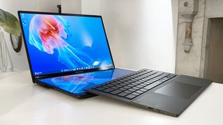 Asus Zenbook Duo (2025) open showing both screens with detachable keyboard resting atop the bottom display