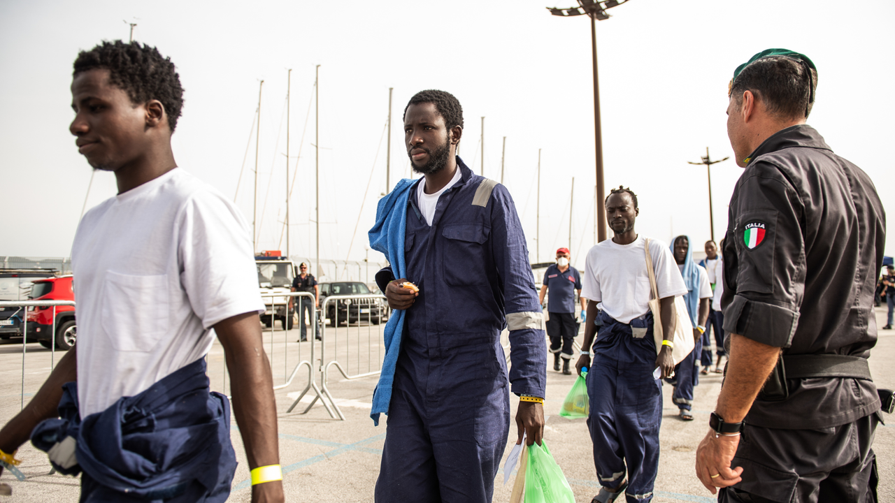 Migrants disembark in the port of Salerno