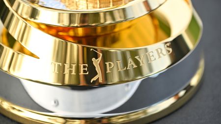 A close-up of The Players logo at the base of the gold trophy