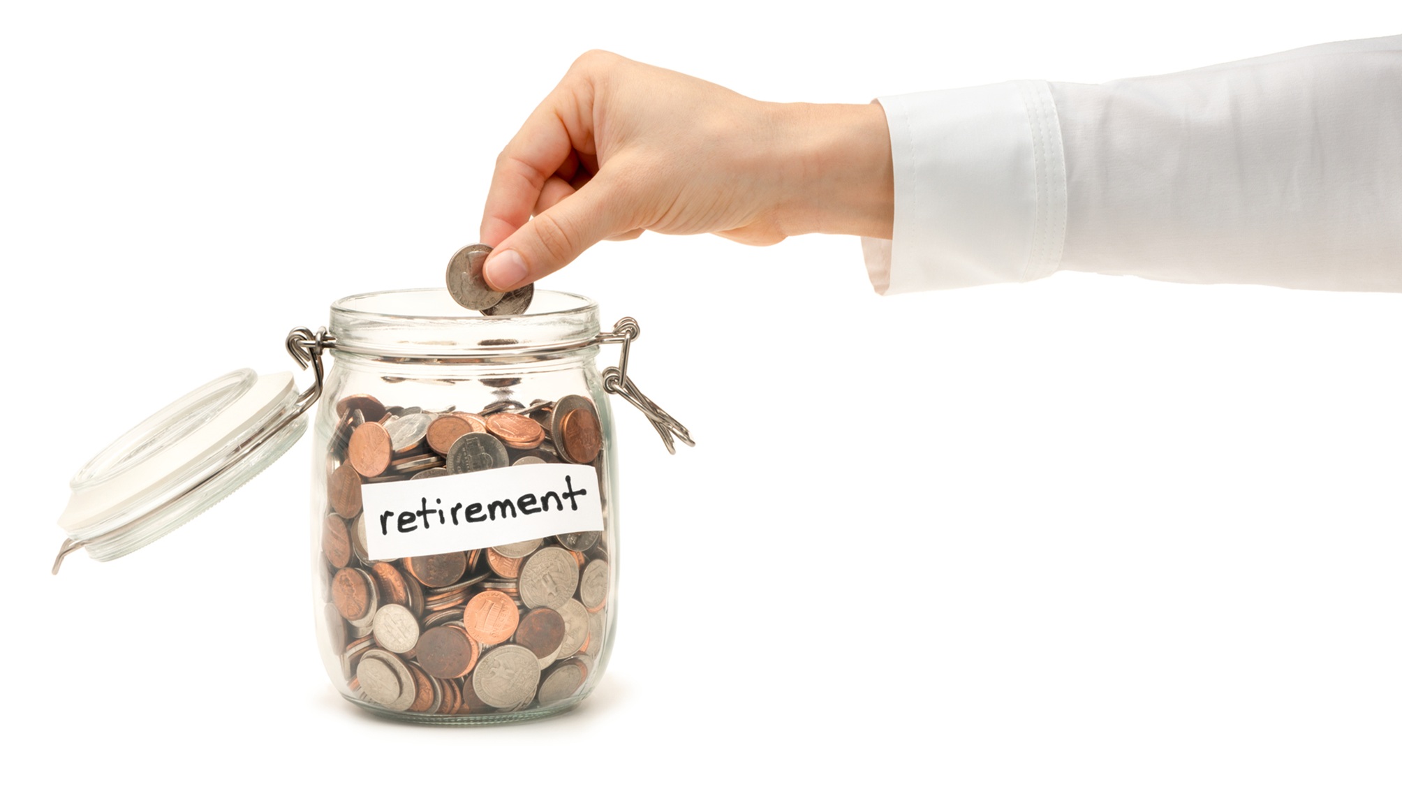 A woman's hand drops coins into a glass jar labeled "retirement."