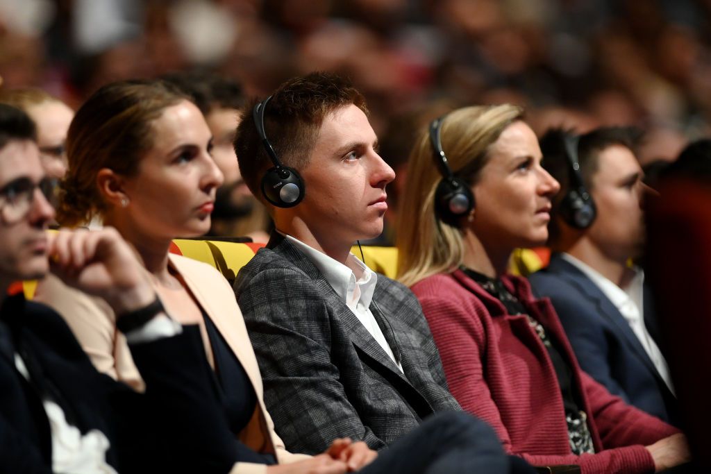 Annemiek Van Vleuten sits alongside Tadej Pogacar at the presentation of the 2023 Tour de France and Tour de France Femmes
