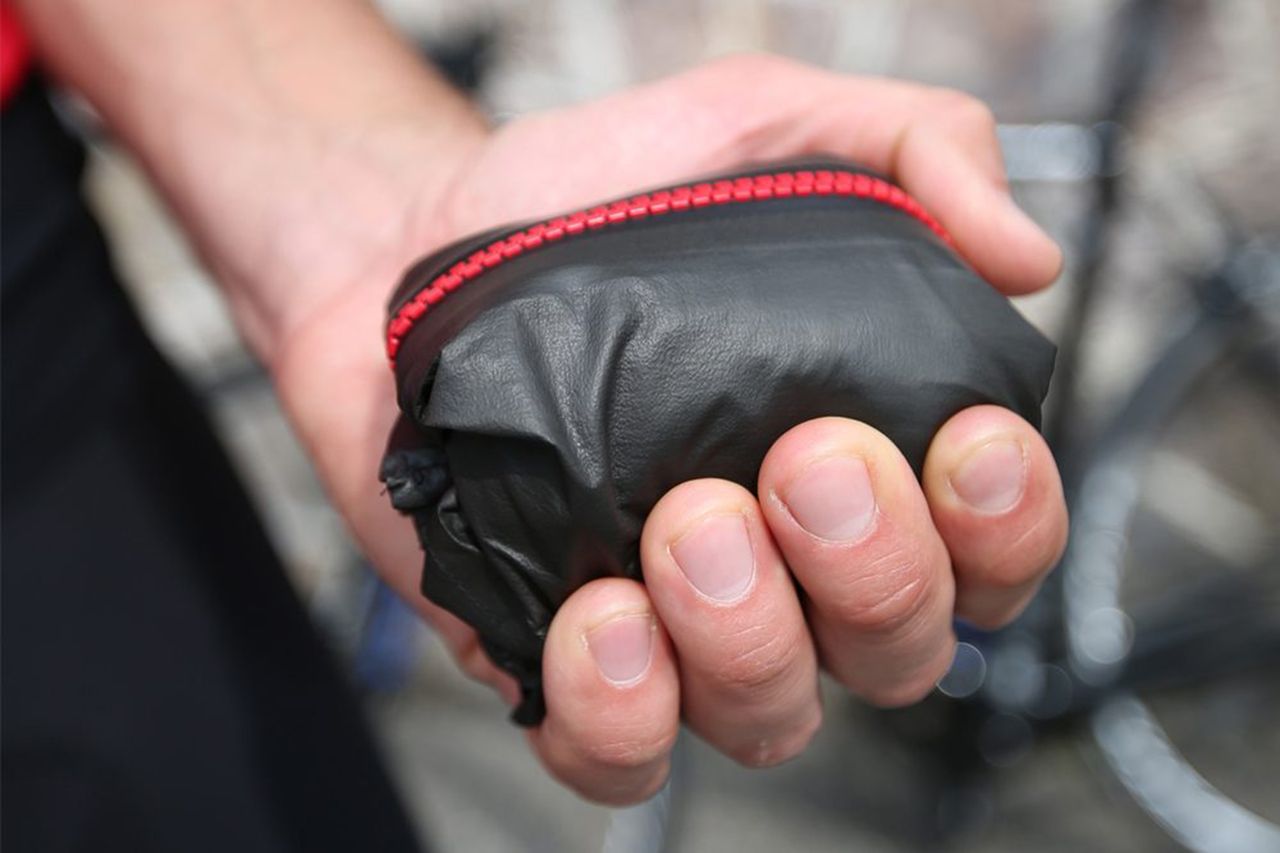 Rain jacket folded down very small in a rider&#039;s hand