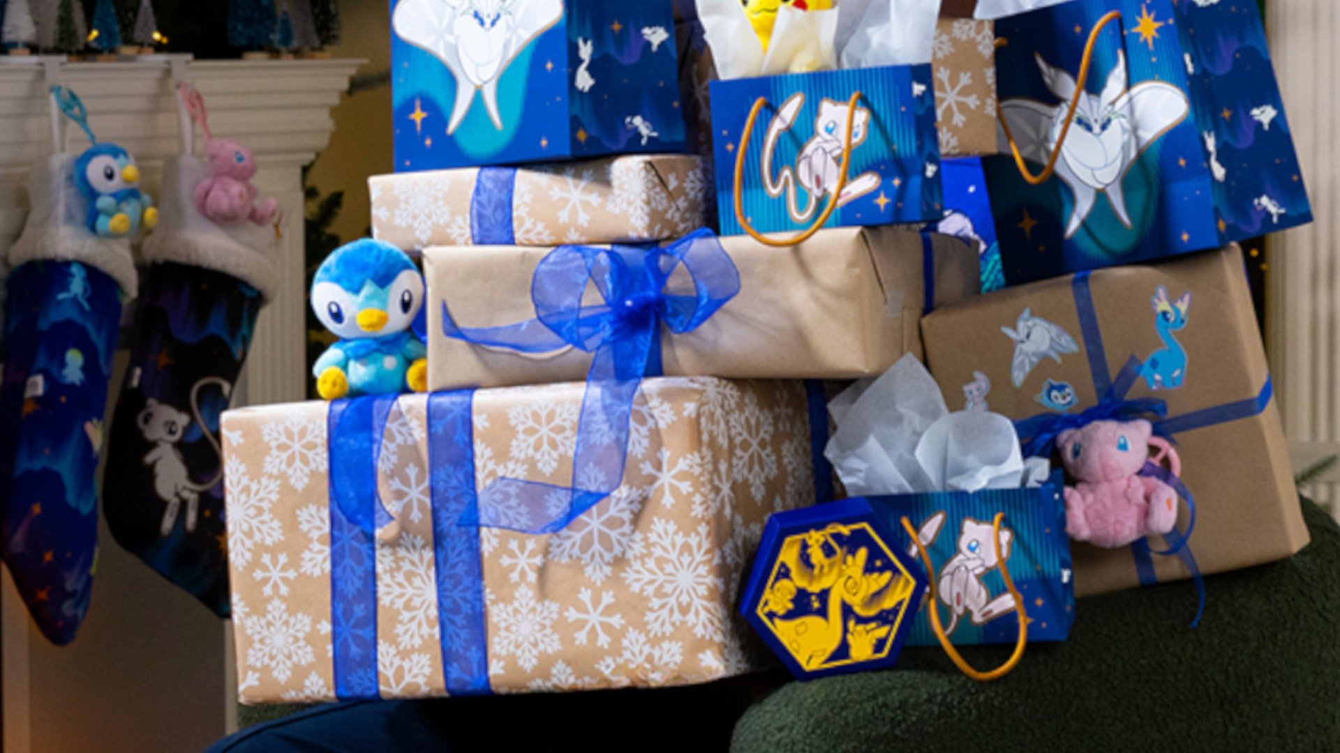 A pile of presents with Pokemon products interspersed in the pile, and a fireplace visible in the background