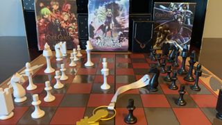 Code Geass collector's edition, with chess set, laid out on a wooden surface