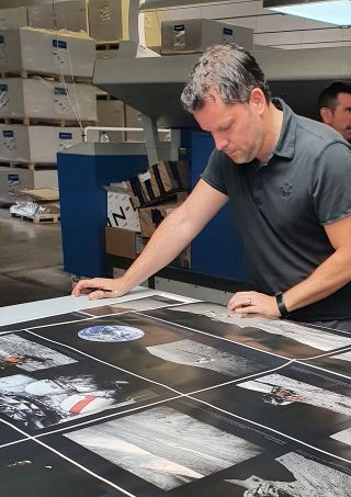 Andy Saunders reviewing photograph and page layouts for "Apollo Remastered" before it went to print.