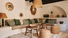 built in corner sofa with an arched enclave and rattan lights in a Mallorca villa 