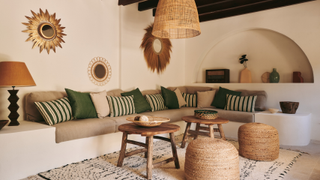 built in corner sofa with an arched enclave and rattan lights in a Mallorca villa 