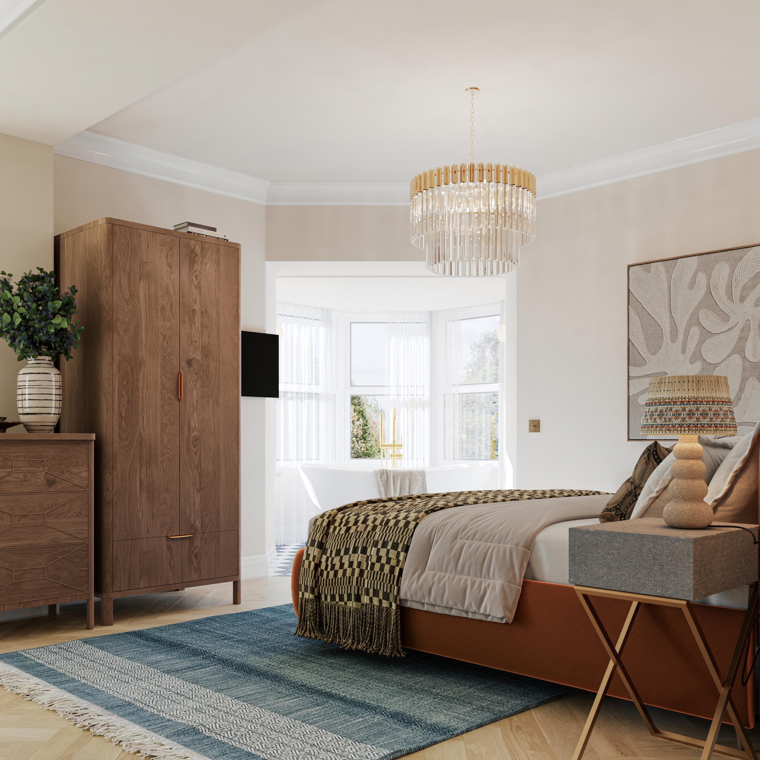 Modern bedroom with a plush bed, patterned throw, and tiered glass chandelier. A wooden wardrobe sits beside a bay window looking into an ensuite bath, over a blue patterned rug