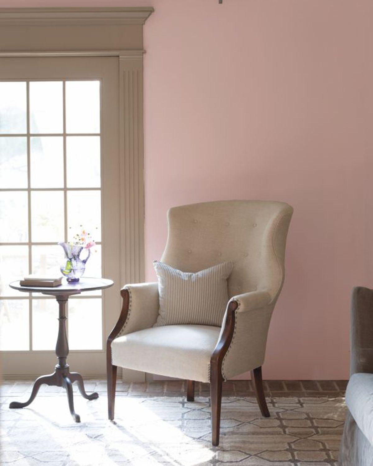 pale pink paint color on living room wall with upholstered armchair