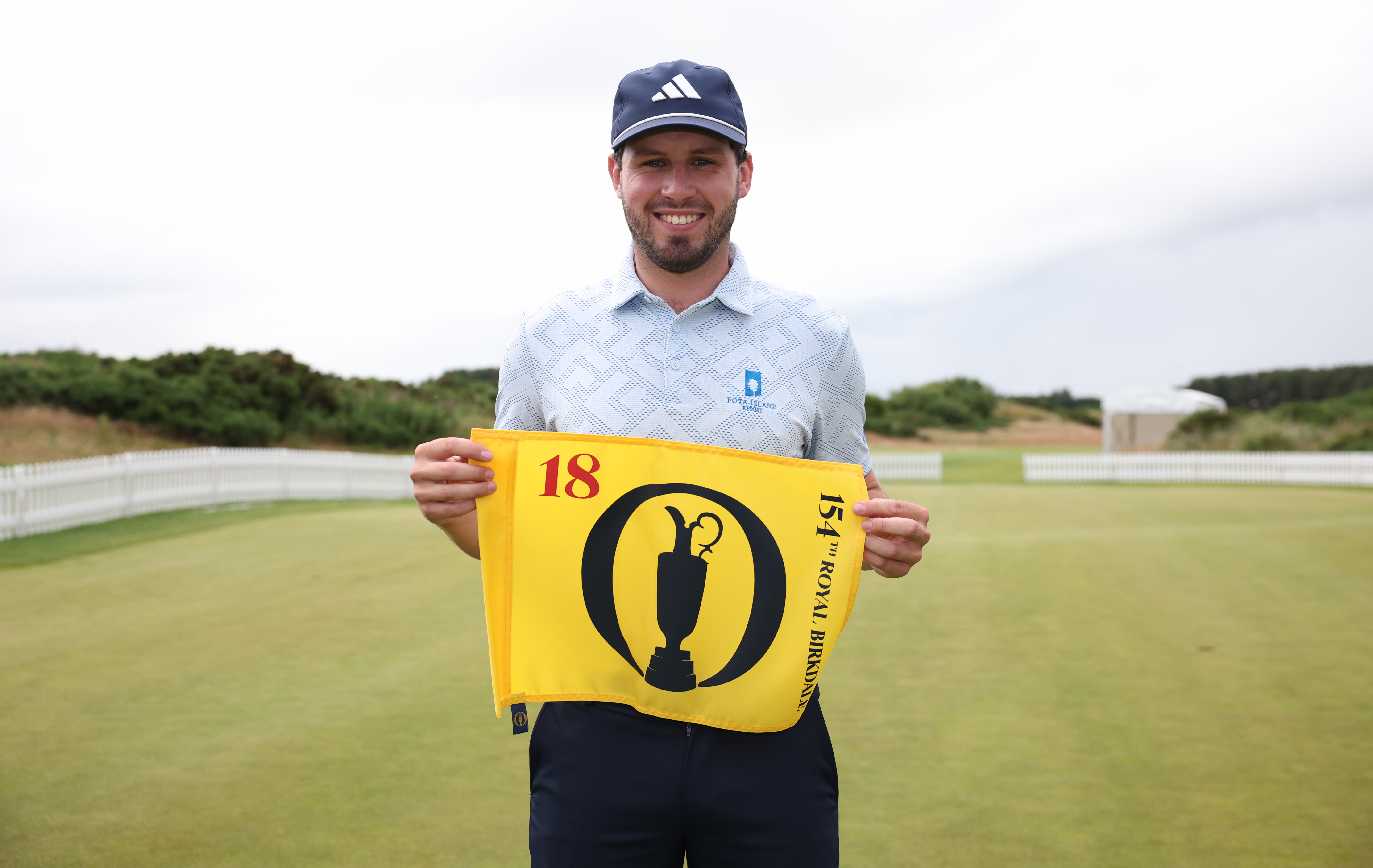 David Howard holds up The Open pin flag after qualifying for The 154th Open at Royal Birkdale at Dundonald Links Golf Course.