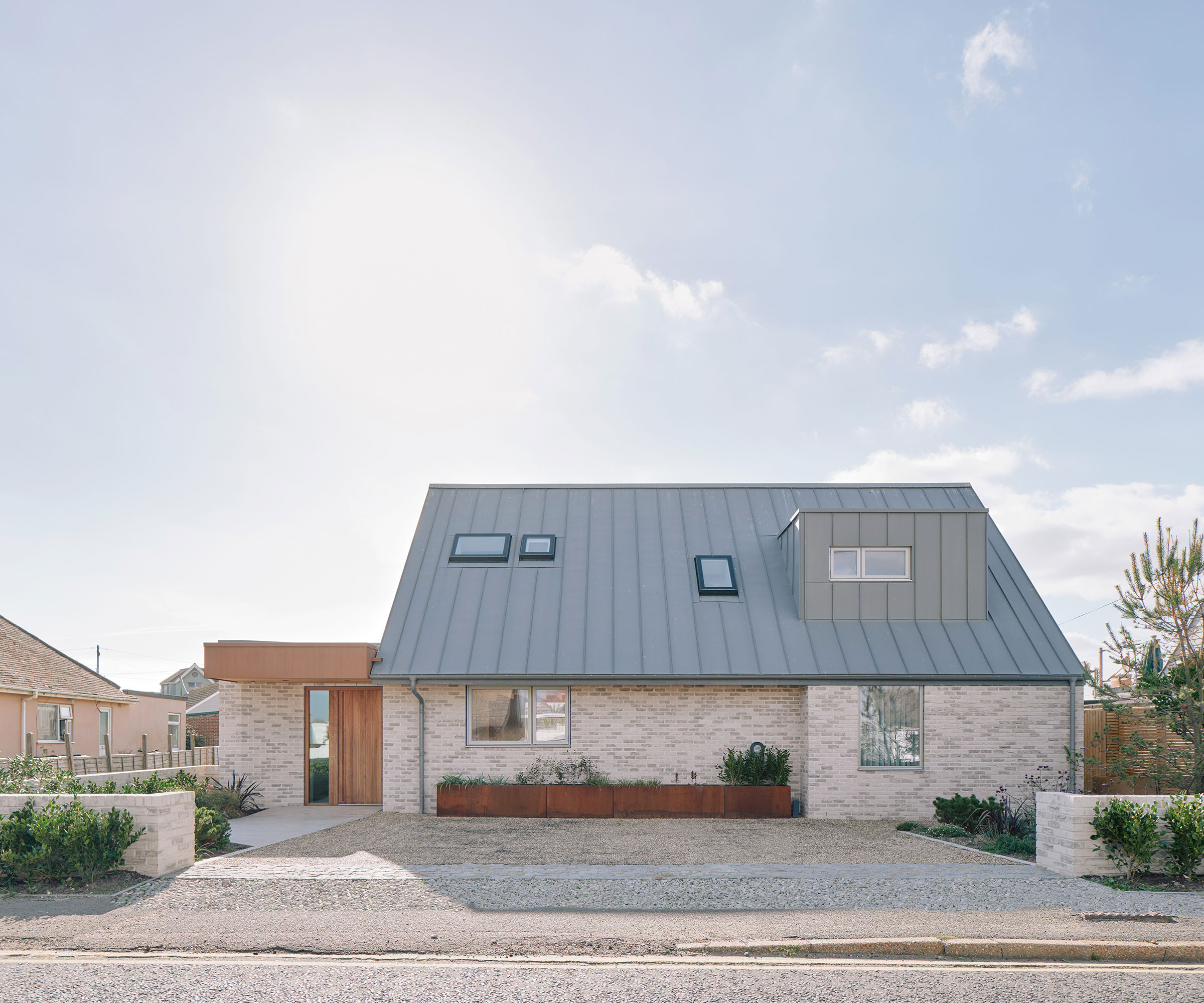 modern dormer bungalow with small driveway with dropped kerb
