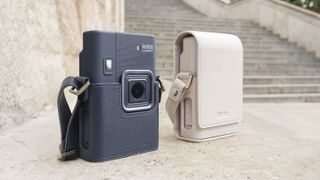 Two Fujifilm Instax mini LiPlay+ hybrid instant cameras side by side in two colorways, besides old steps