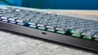 A black Keychron K13 Max wireless keyboard with gray and orange keycaps