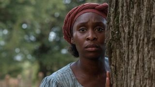 Cynthia Erivo as Harriet Tubman in Harriet, looking pensive peering around a corner