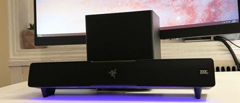 A Razer Leviathan V2 in front of a monitor.