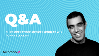 headshot of Ronny Elkayam COO of Wix against a spiral backdrop in blue