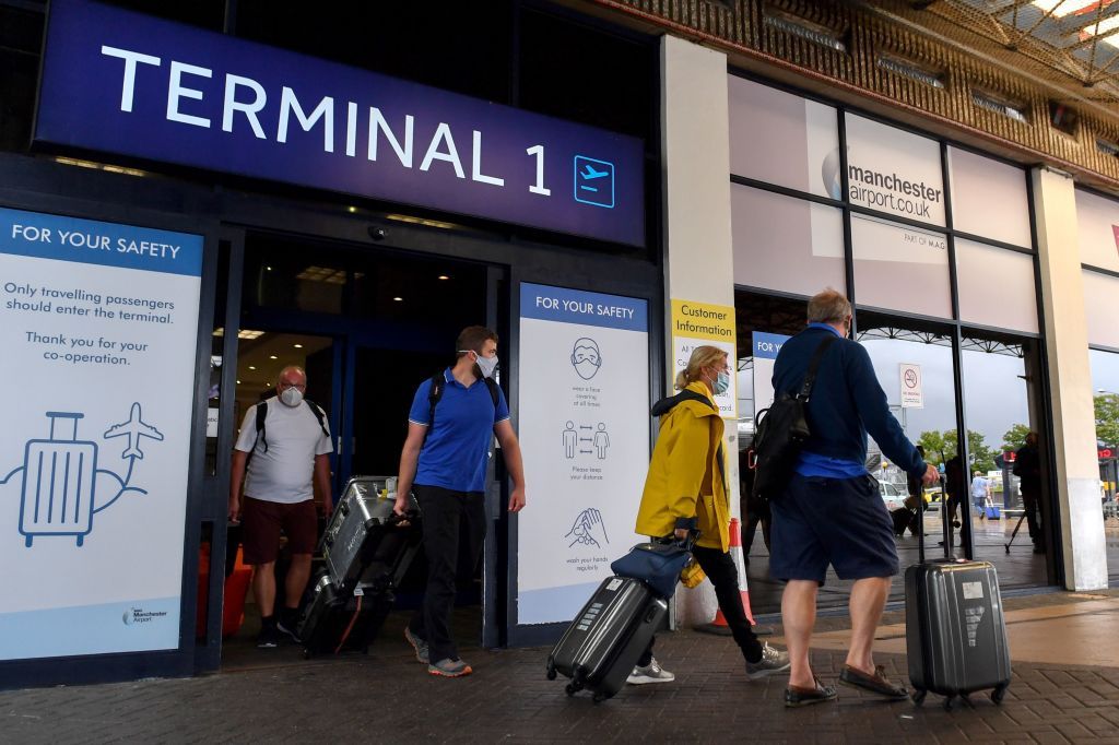 Passengers arriving at Manchester airport.