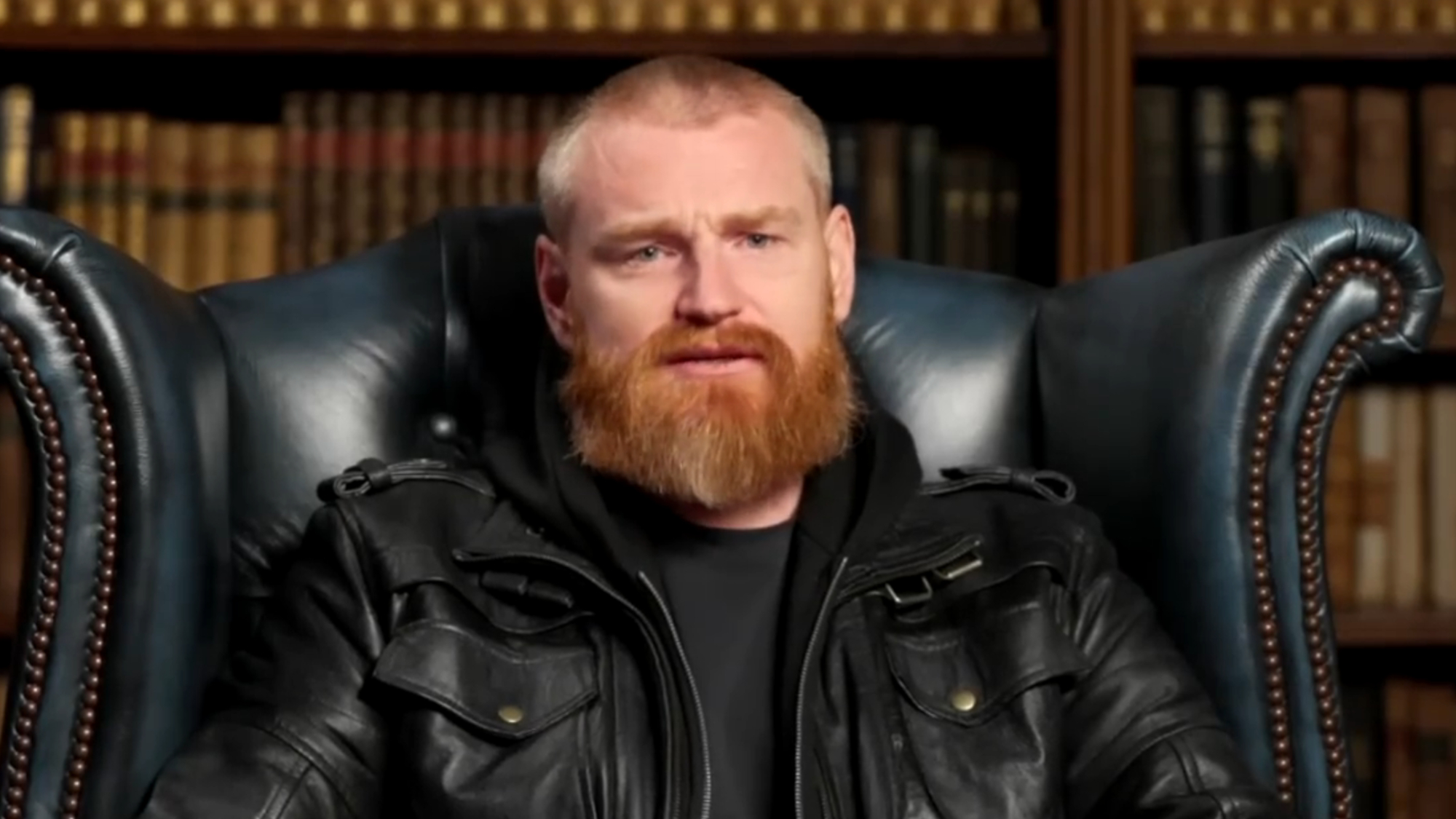 Wes talks while sitting in a chair in the library on The Traitors.