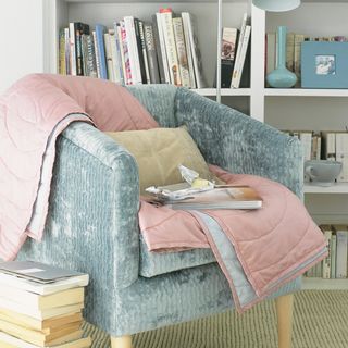 book shelf with armchair and cushion