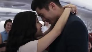 Constance Wu with her arms around Henry Golding in Crazy Rich Asians