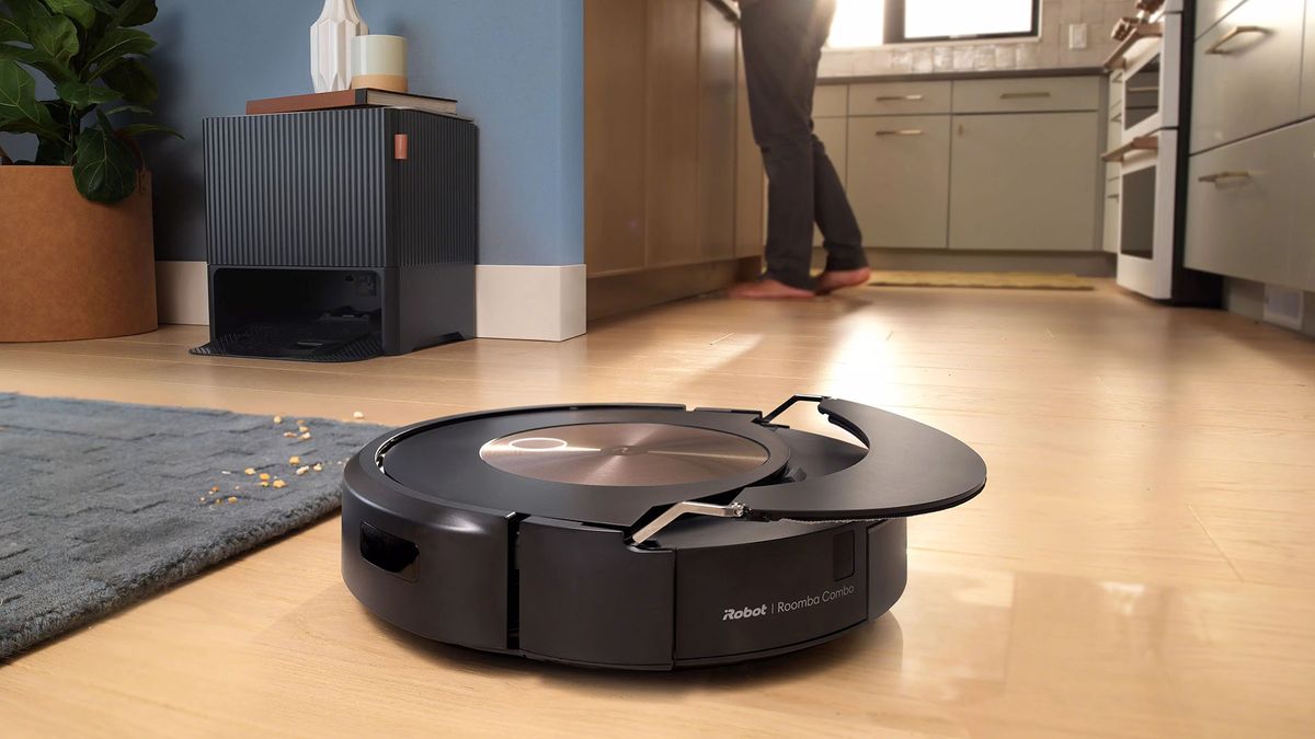 Roomba on a hard floor with its mop pad lifted