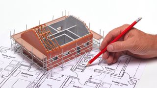 model of house on top of architectural plans