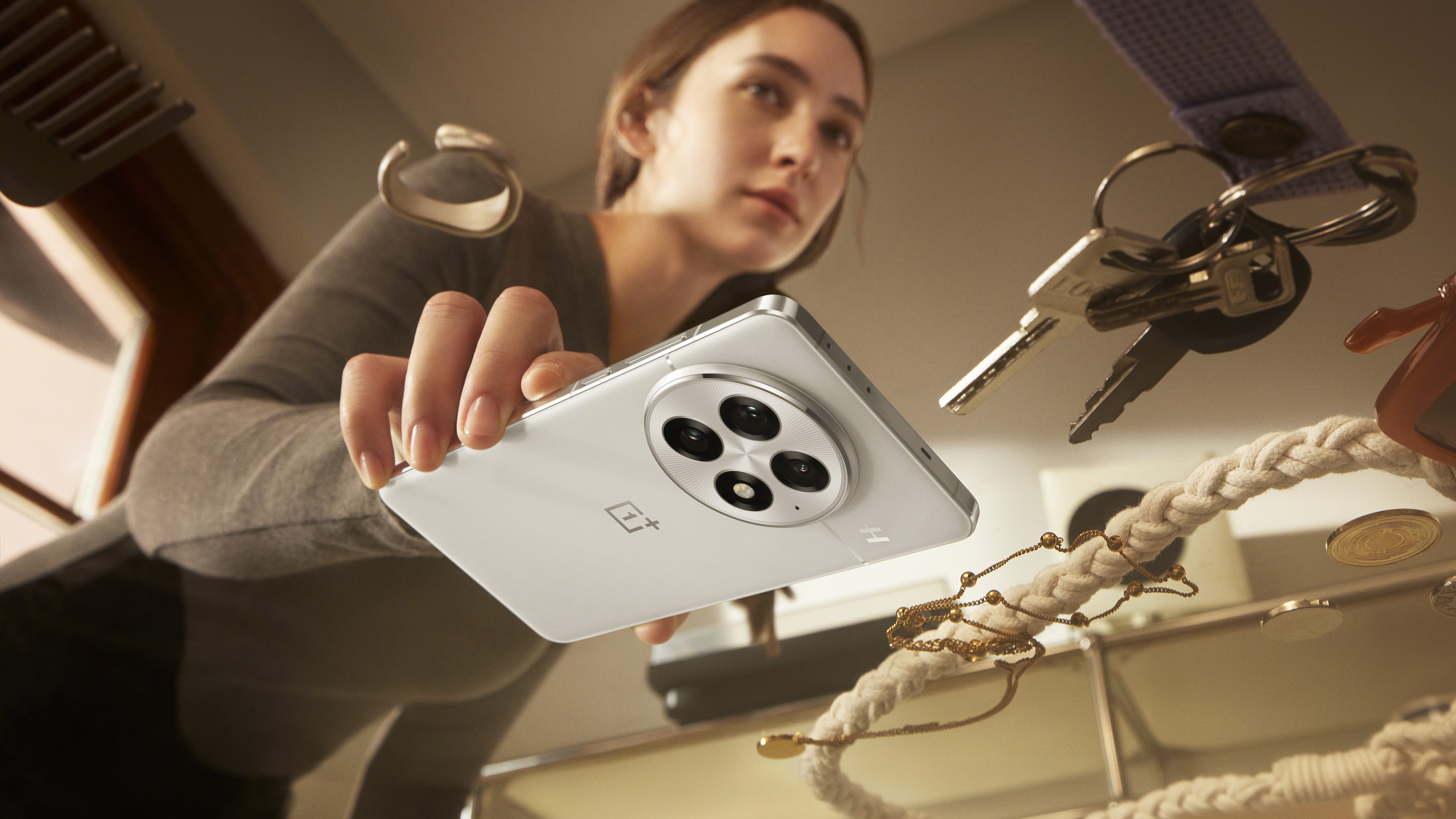 A woman setting the OnePlus 13 down on a table