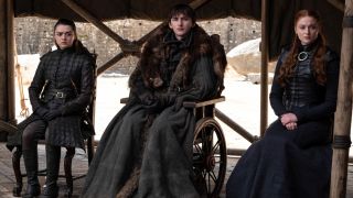 From left to right: Arya, Bran and Sansa sitting next to each other in Game of Thrones.