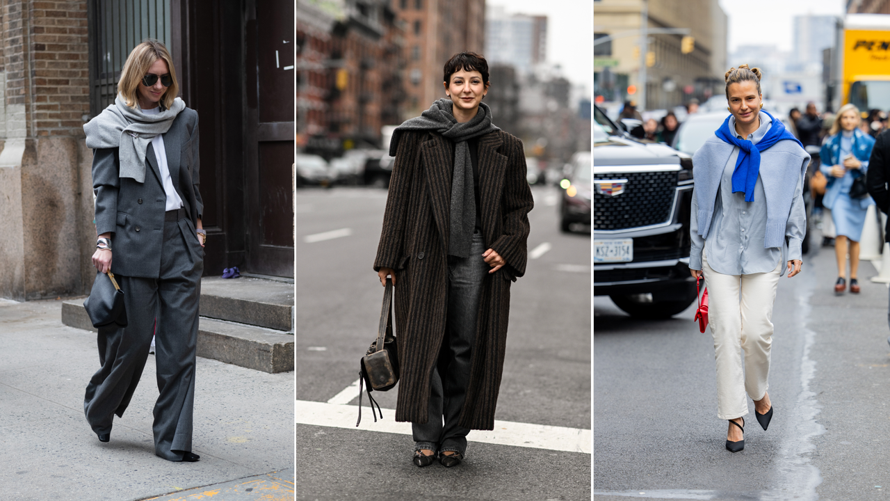 Three women at fashion week wearing sweaters over their coats