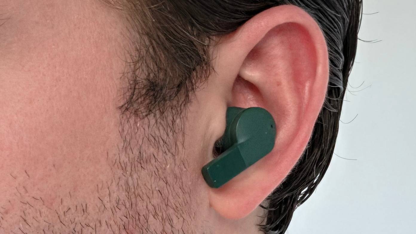 The Fairphone FairBuds 2 in a man's ear.