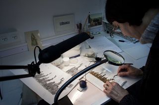 Shown in this image, a conservation analyst from the Israeli Antiquities examines fragments of the 2000-year-old Dead Sea scrolls at a laboratory before photographing them on Dec. 18, 2012, in Jerusalem.